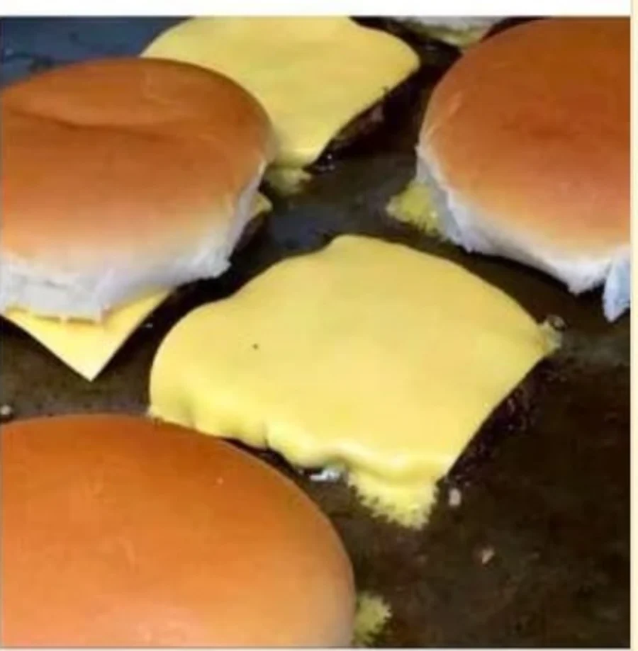 Cheeseburgers cooking on the flat top