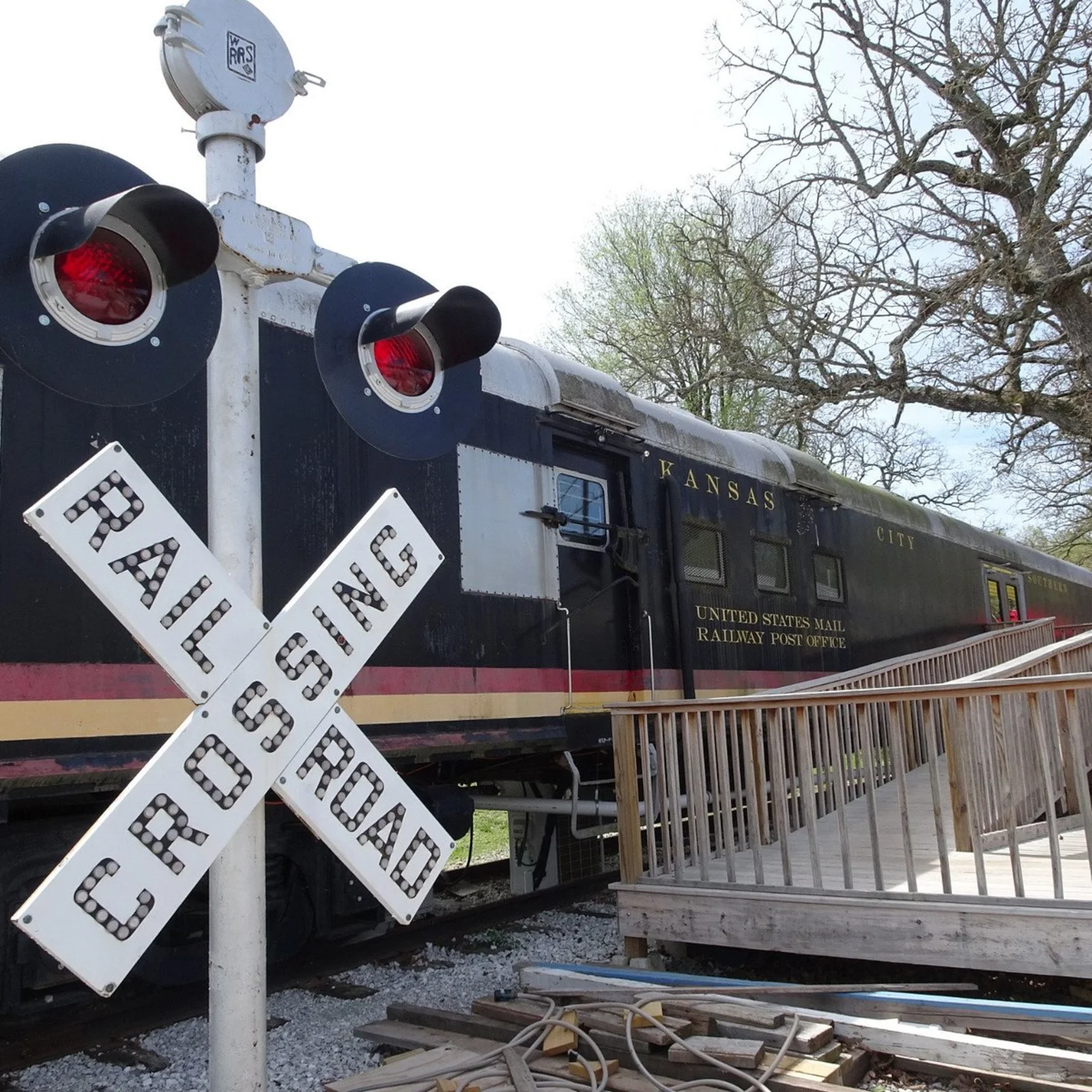 Railroad crossing sign beside the train car