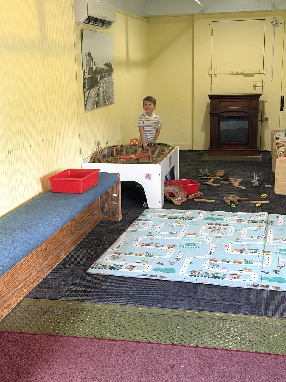 Child playing with trains inside the train room